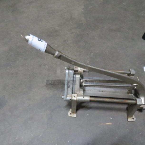 Heavy-duty fry/vegetable cutter with a long lever and metal frame, used condition, suitable for efficient food preparation.