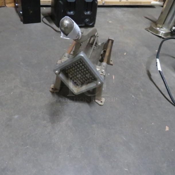 Industrial fry/vegetable cutter with grid blade attachment, metal construction, shows moderate wear.