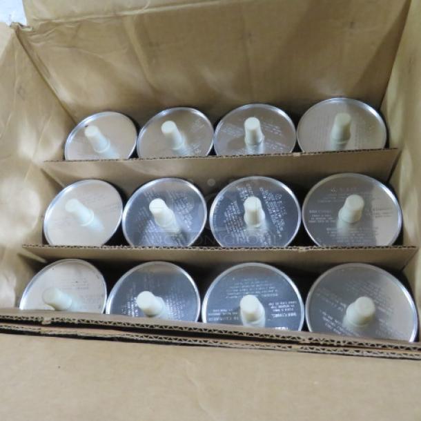 One lot of 12 chafer fuel cans in a cardboard box, each with visible wicks and labeling on lids.