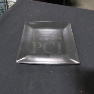 8-inch square World Market plate, black, ceramic, gently used with minor scuffs, smooth finish.