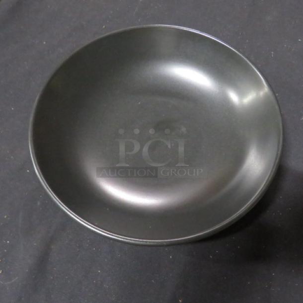 Black 9-inch bowl, smooth finish, model 7XBID. Excellent condition, round shape, minimal wear.
