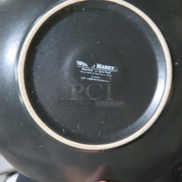 9-inch black ceramic bowl with a "WOOD & MARTE" marking indicating "Made in Cyprus."