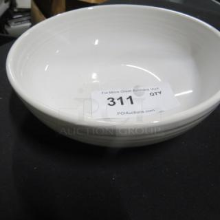 Nine-inch white Fiesta bowl in excellent condition, displaying subtle ribbed detailing. Auction tag '311' visible inside.