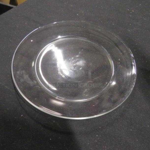 8-inch clear glass plate, round, smooth finish, no visible markings, in good condition.