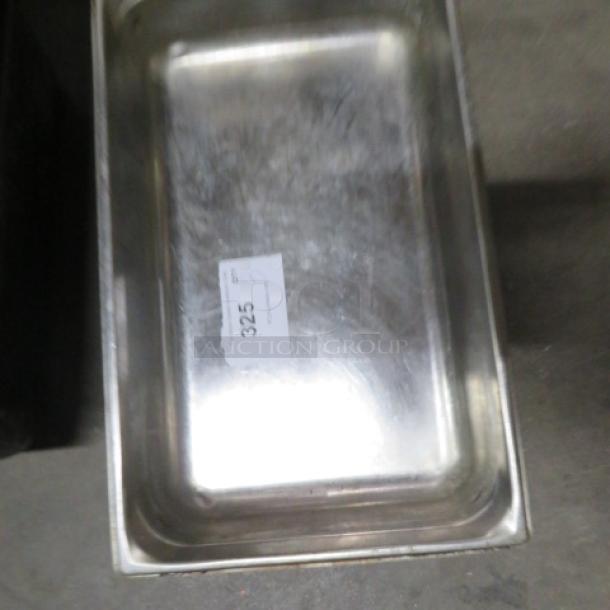 Full-size 4-inch deep stainless steel hotel pan. Light wear visible. Label with code "325" on surface.