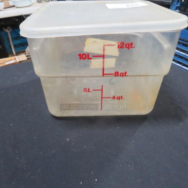 Clear 12-quart food storage container with lid, marked with red measurement lines in liters and quarts. Used condition.