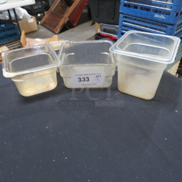 Assorted food storage containers, translucent plastic, square shape, used condition. Auction tag "333" visible.