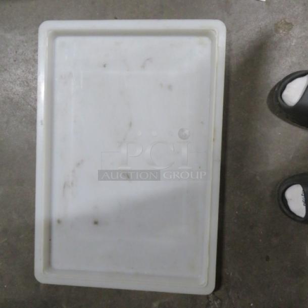 White rectangular food storage lid, model 2XBID. Used condition with visible stains and scuffs.