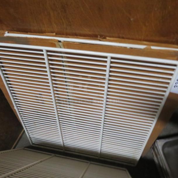 White metal rack, 22x24 inches, in good condition, with fine grid design, suitable for storage or shelving.