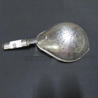 Stainless steel strainer with perforated bowl, short handle, and visible tag marked "40." Slight tarnish, good condition.