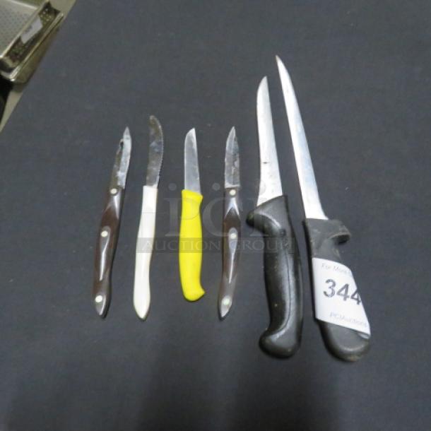 Assorted chef knives set, six pieces, various handle colors, moderate wear, tagged "344" for auction identification.