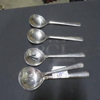 Lot of 6 slotted silver serving spoons; used condition with visible slotted designs; metal finish shows light wear.