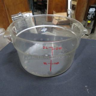 Clear 2-quart food storage container with 1L and 2L red measurement markings, featuring sturdy handles; used condition.