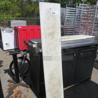 60x12 cutting board, used condition, rectangular shape, visible wear, outdoors Among industry equipment, tagged "346".