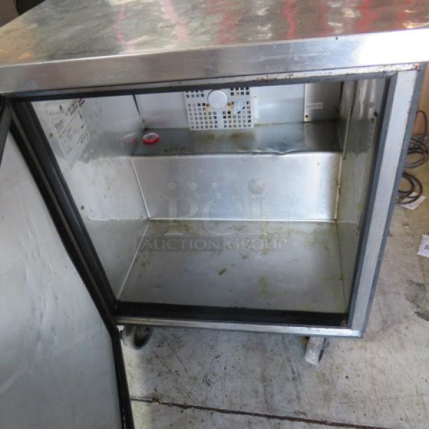 True TWT-27F one-door worktop freezer on casters, 27.5x30x35.5 inches. Features stainless steel exterior and working condition.