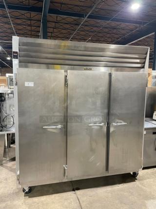 Traulsen G-Series 3-door stainless steel commercial freezer, Model G31011, on casters, with poly-coated wire rack.