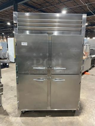 Traulsen Spec Line AHT232NUTHHS commercial stainless steel half-door refrigerator with chrome racks, on casters.