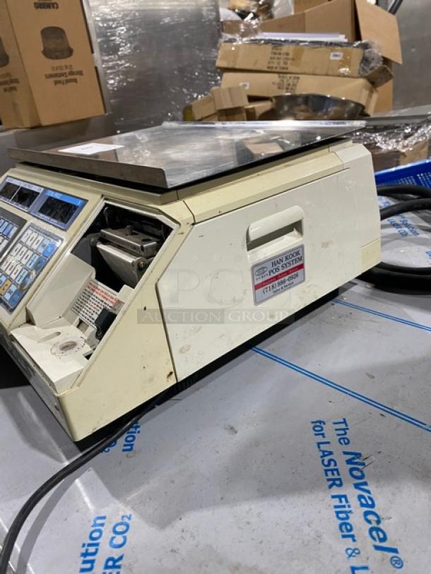 CAS-USA LP-1000 digital scale with label printer, 30 lb capacity, stainless steel worktop. Used condition, 120V, on legs.