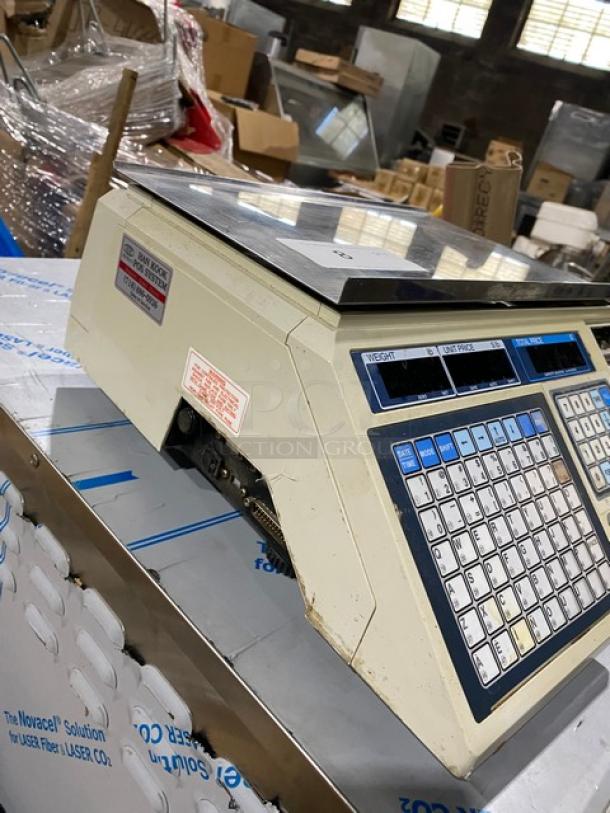 CAS-USA LP-1000 countertop digital price computing scale with label printer, stainless steel worktop, on legs, 120V.