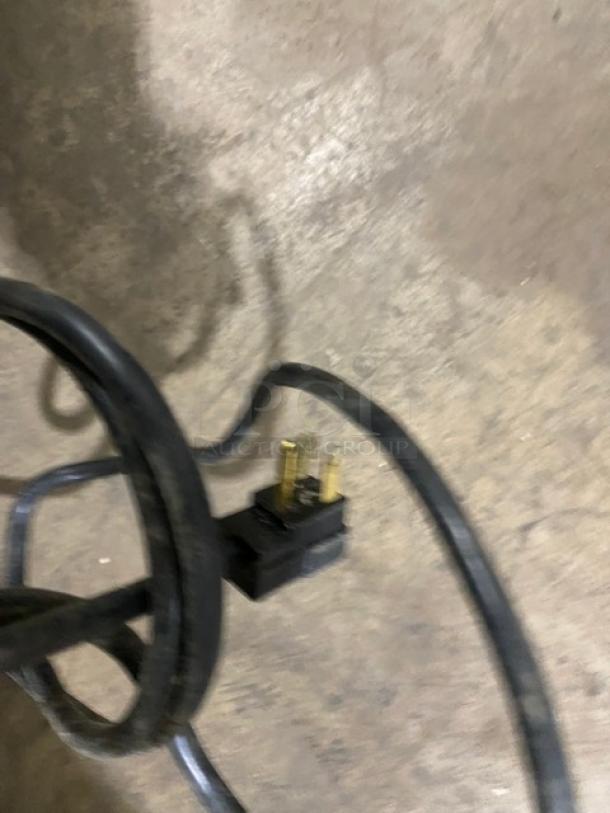 Power cord and plug for Beverage-Air Vista Series refrigerator, model RB23HC-1S-18, visible on the ground.