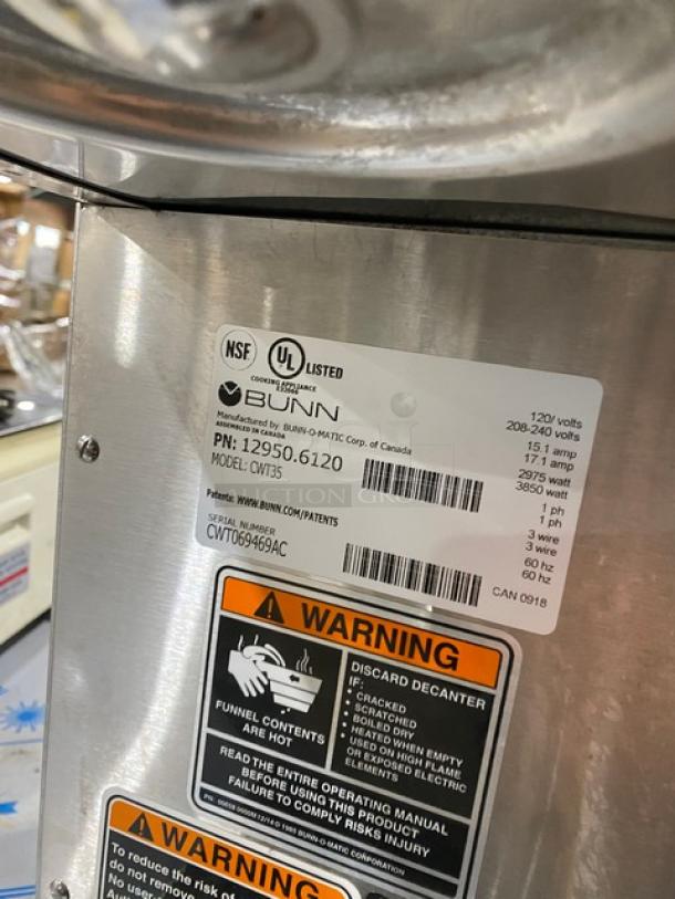 Bunn CW Series CWT35 coffee brewing machine with dual warmer plates, stainless steel brew basket, NSF/UL listed, model CWT35, SN: CWT069469AC, 120V, 1 phase.
