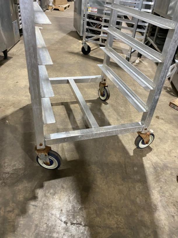 Alexander Industries heavy-duty pan holding/transport rack on casters, metallic frame, multiple shelves, used condition.