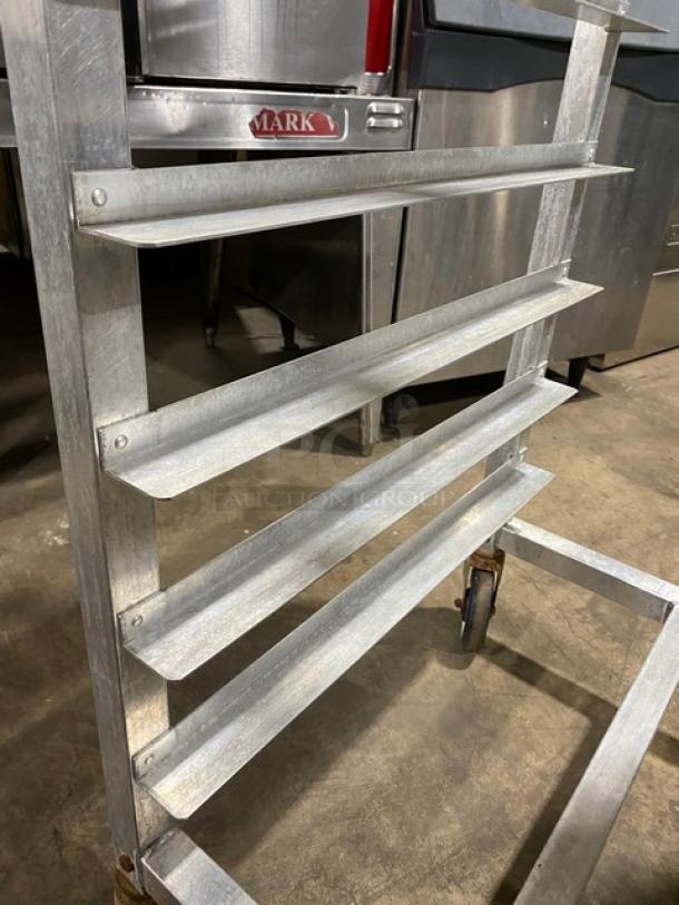 Alexander Industries heavy-duty pan transport rack with multiple shelves, on casters, in good condition.