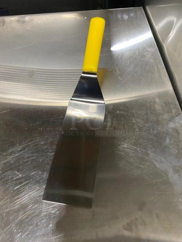 Dexter Russell 8"x3" stainless steel turner, model 31989Y, with yellow grip handle. New condition.
