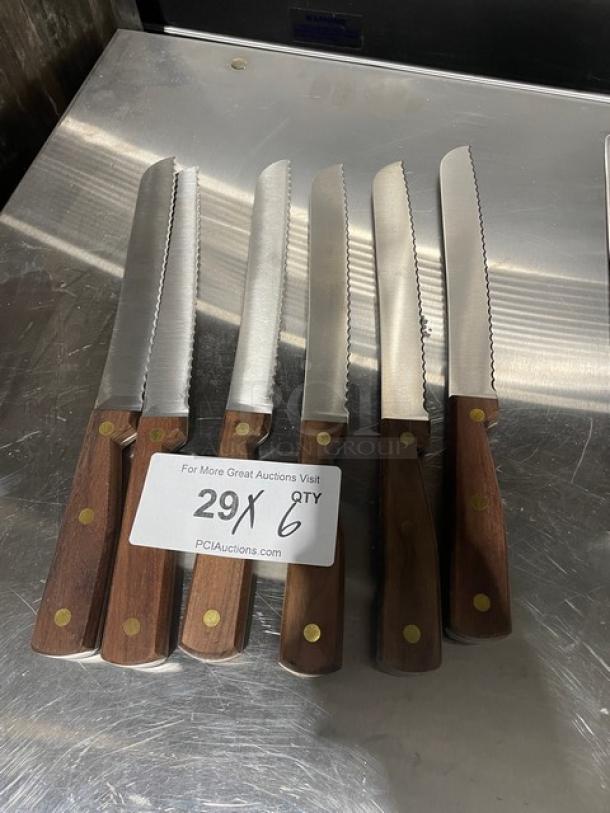 Six Dexter Russell 8" bread knives, model 628, with stainless steel blades and traditional wooden handles, new condition.
