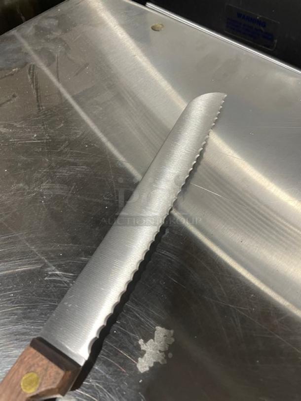 Dexter Russell 8" bread knife, model 628, stainless steel blade with wooden grip handle, new condition.