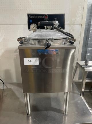 Broaster Smokaroma Series commercial stainless steel electric pressure smoker on legs, with gauges and label showing model details.