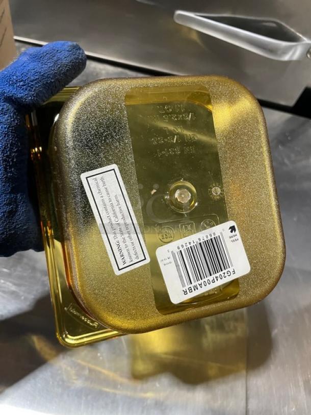Brand new Rubbermaid Commercial Amber 1/6-size high heat food pan, 2.5" deep, model FG204P00AMBR, with label and barcode.
