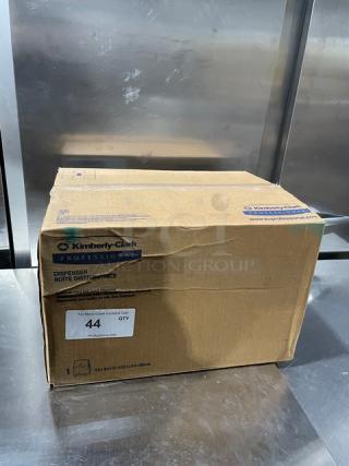 Brand new Kimberly Clark Professional Series Sanitouch dispenser box, smoke black, model marked for commercial use.