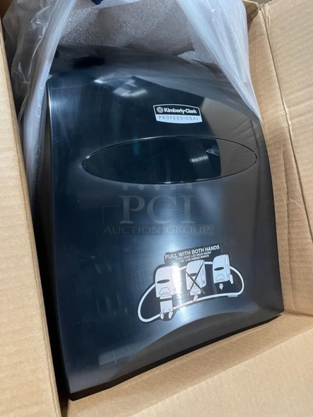 Brand new Kimberly Clark Professional Series smoke black Sanitouch hard-roll towel dispenser in box, with clear instructions.