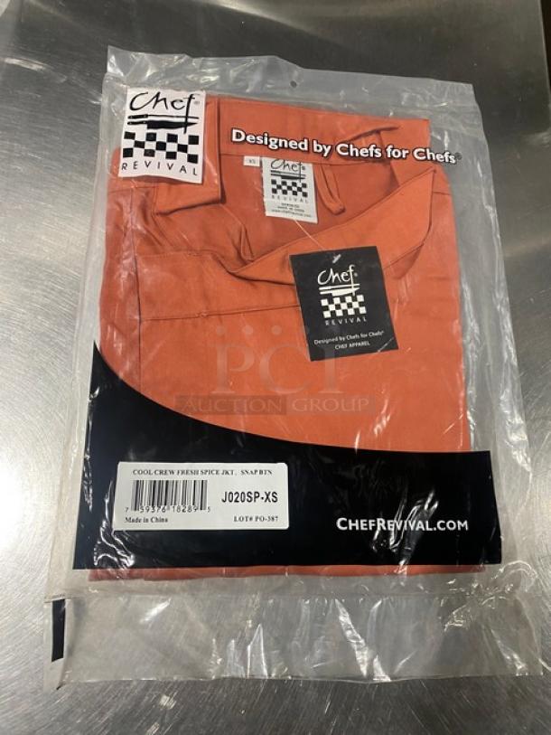 Brand new Chef Revival 24/7 Series red spice jacket, XS size, model J020SP-XS, with snap buttons, in packaging.