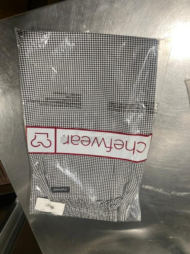 Brand new Chefwear Black & White Medium Chef Pants, Model CW11, in original packaging, showcasing houndstooth pattern.