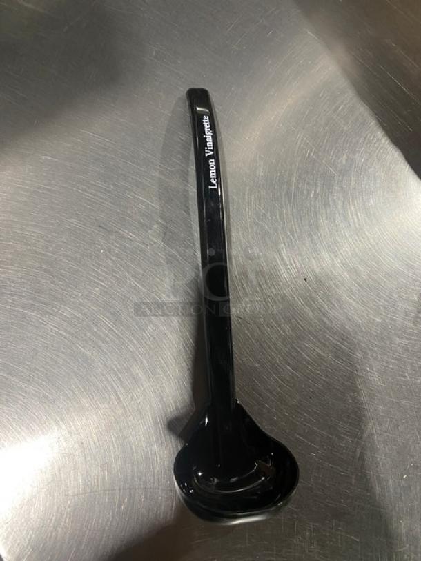 Brand new Carlisle 9.5" black lemon vinaigrette ladle, model 02955979, labeled "Lemon Vinaigrette."
