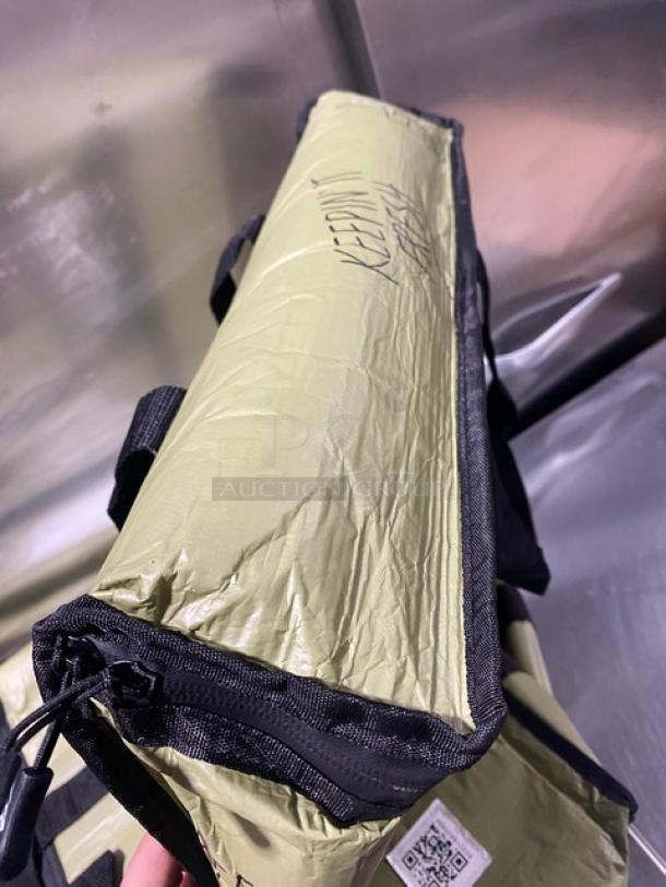 New green insulated fast food delivery carrier bag, commercial-grade, features "Keepin' Fresh" text and QR code tag.