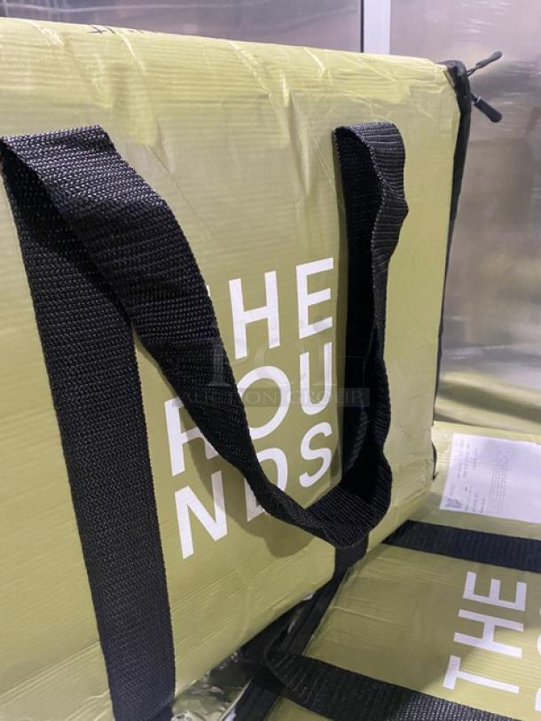 New green insulated fast food delivery carrier bag by The Rounds, with black straps and bold white branding.
