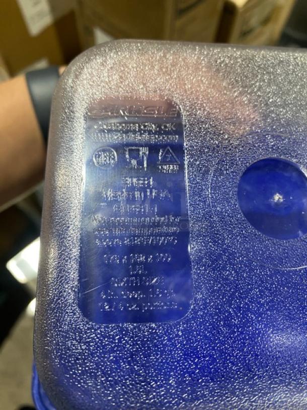 Carlisle clear polycarbonate food storage container with blue lid, textured exterior, brand markings visible, new condition.