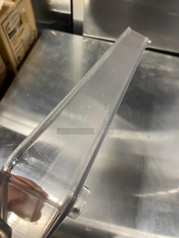 Commercial clear polycarbonate stackable container, rectangular shape, transparent material, clean condition.