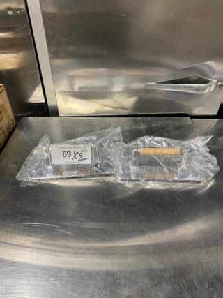 Brand new Vollrath Model 47709 cast aluminum steak weight, waffle-patterned, with wooden handle, in packaging.