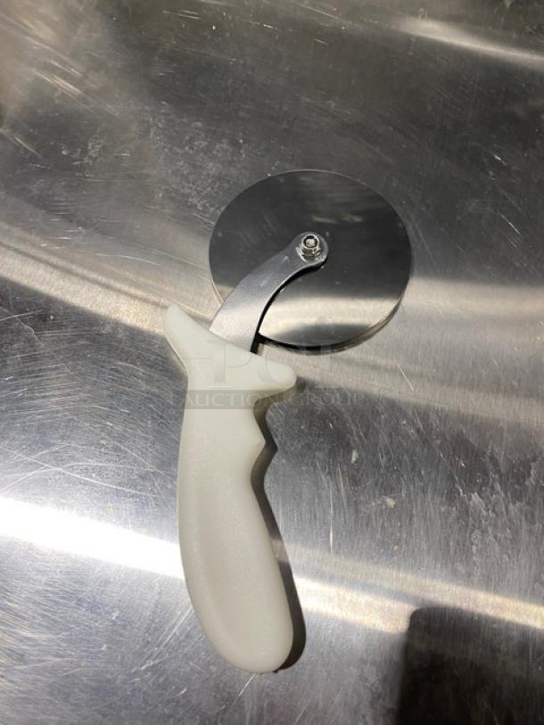 Brand new Dexter Russell Sani-Safe 4" pizza cutter, stainless steel blade, white grip handle, model PCP4.