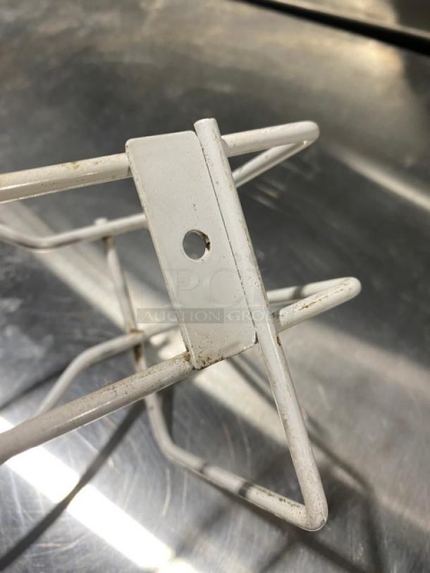 White wired wall-mount glove box holder, slightly worn, features a mounting hole for easy installation.
