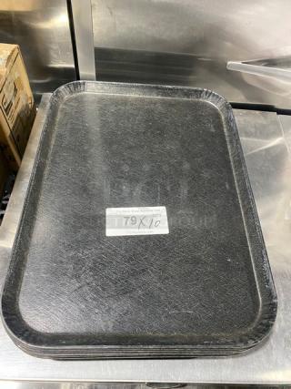 Commercial black rectangular fast food serving tray, durable plastic, slight wear. Label reads "79X/10". Value opportunity.