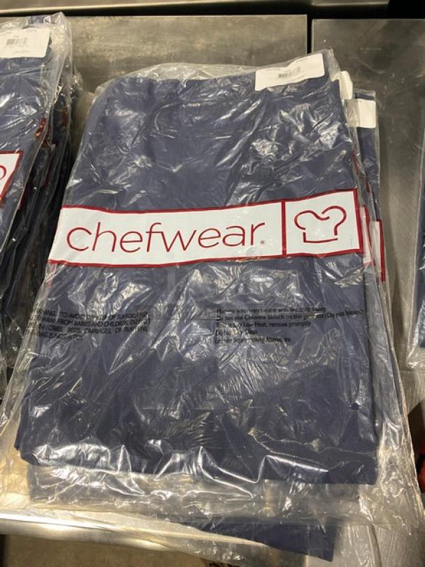 Brand new Chefwear commercial navy-blue chef apron, model CW1648-CW73, with two pockets. Still in packaging.