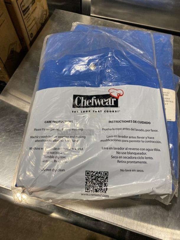 Brand new Chefwear Model 4931 blue polyester/cotton blend bar jacket, size 5X, in packaging with care instructions.