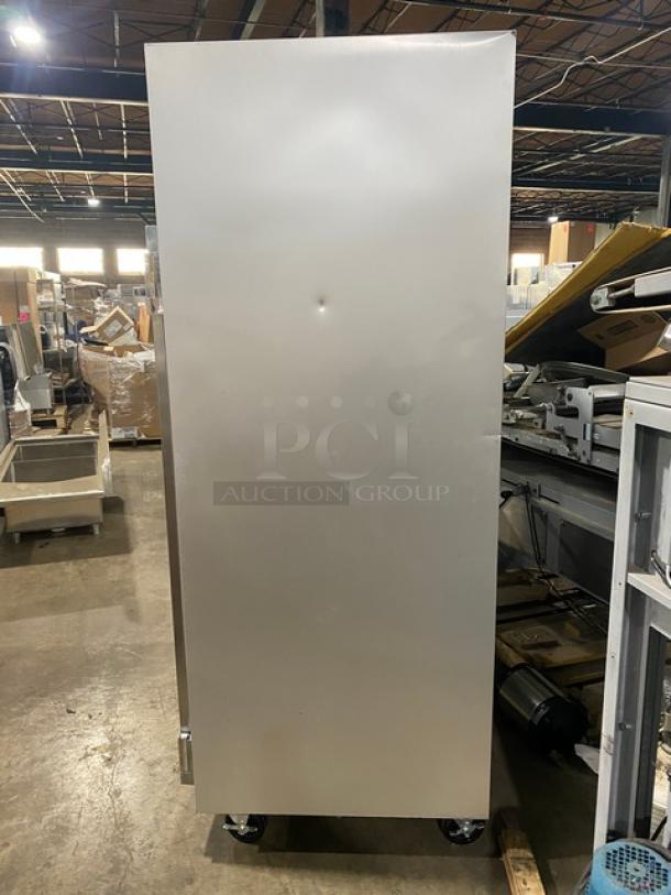 Traulsen G-Series 2 Door Reach-In Freezer, Model G22010, stainless steel, on casters, dented door, includes poly-coated wire rack.