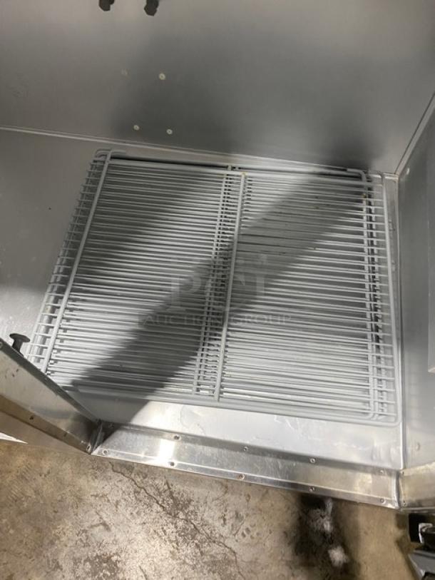 Traulsen G-Series stainless steel freezer, model G22010, featuring a poly-coated wire rack, shown on casters.
