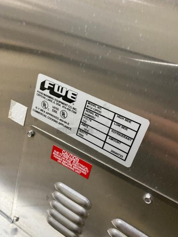 FWE MTU12PDD stainless steel heated holding cabinet with Dutch doors, 12-pan capacity, adjustable trays, and moisture-temp system.